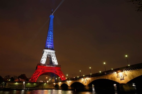 The Eiffel Tower is lit with the colors of the French flag in Paris on Nov. 16, 2015, to pay tribute to the victims of a series of deadly attacks on Friday in the French capital. BENOIT TESSIER / Reuters